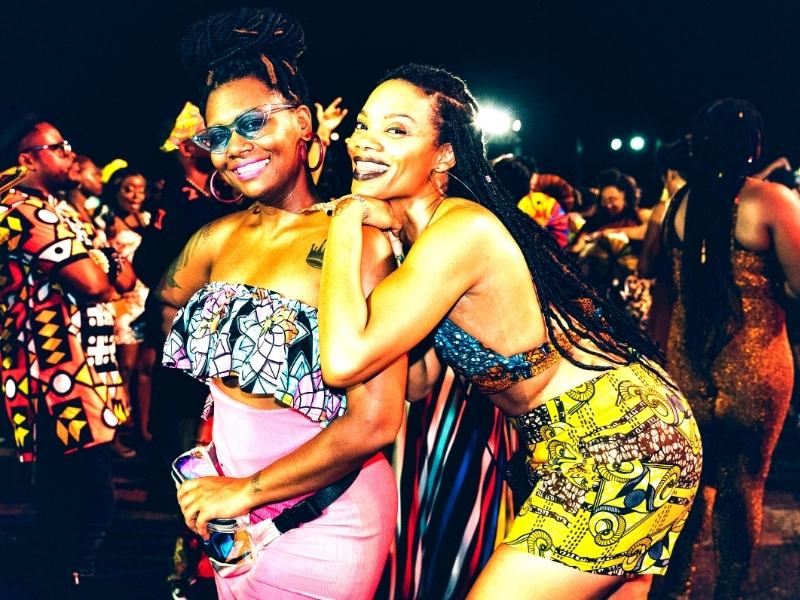women at an Afro-Caribbean music festival wearing cultural attire
