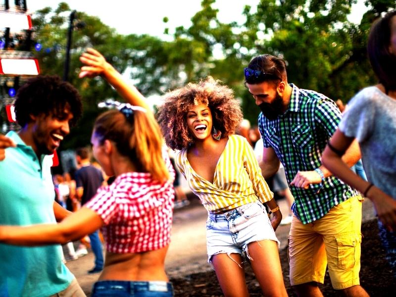 guys and girls dancing at a music festival
